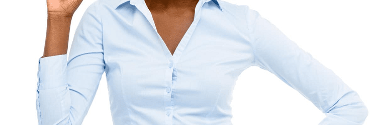 A person wearing a light blue button-up shirt stands with one hand on their hip and the other hand raised near their face, possibly reacting to a minor wardrobe mishap. Wardrobe malfunction